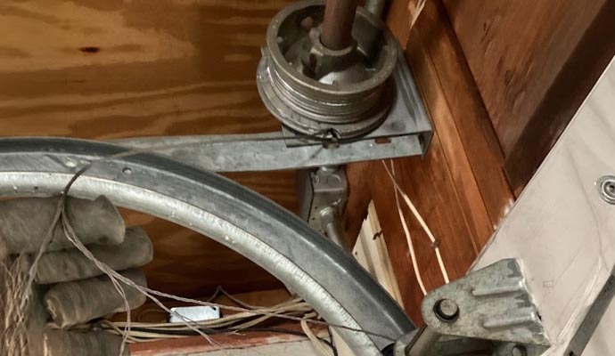 A close-up view of a broken garage door cable