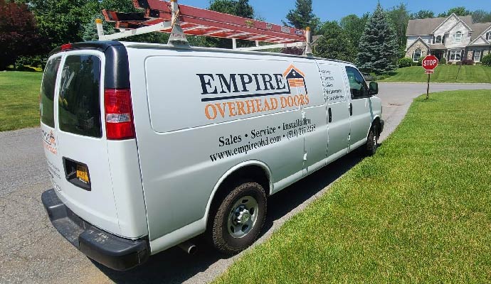 Empire Overhead Doors service van parked in a neighborhood