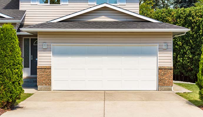 New residential garage door installed on a house