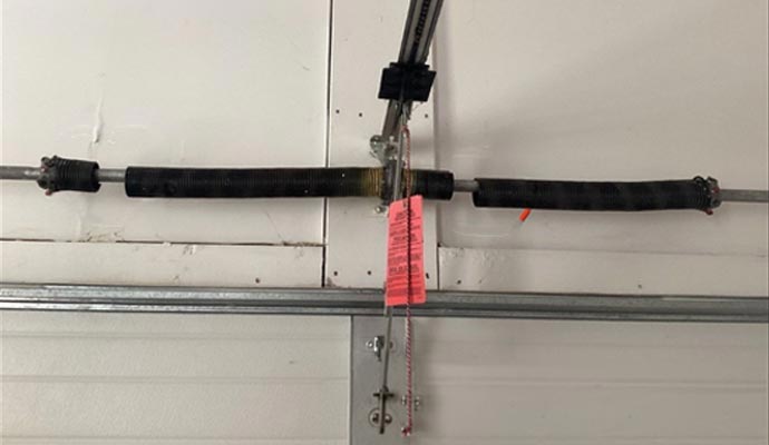 Broken garage door torsion spring on shaft