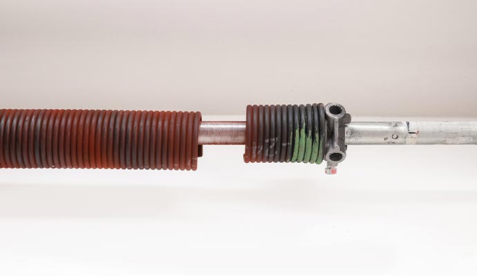 Close-up view of a broken garage door spring