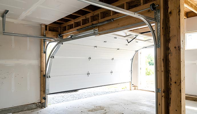 Sectional garage door on curved overhead tracks