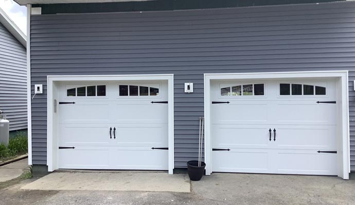 Two white color garage door with installed panel