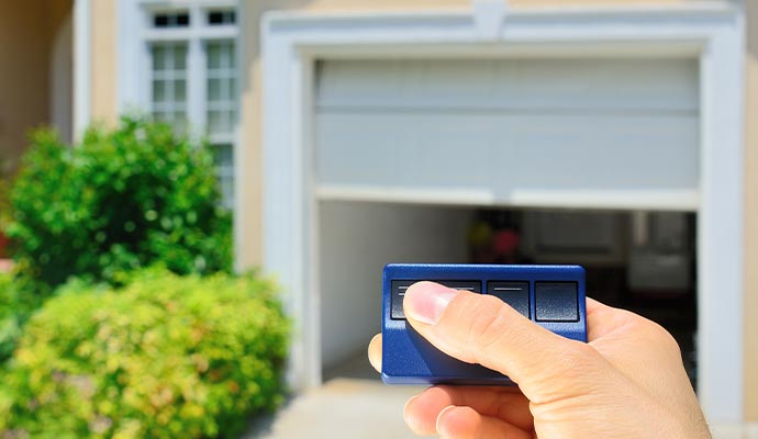 Person controlling garage door using remote