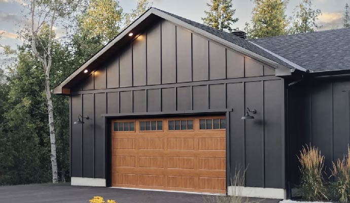 Modern farmhouse garage with a woodgrain Clopay garage door
