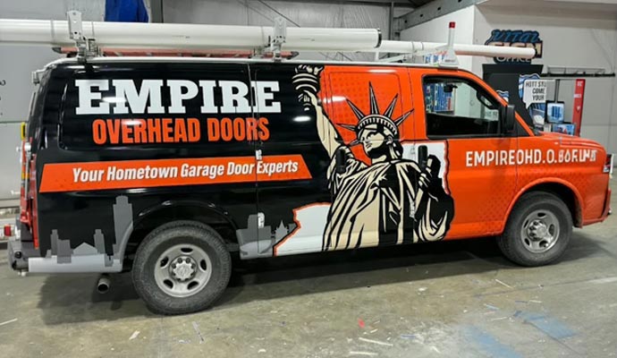A fully equipped Empire Overhead Doors service vehicle parked in a warehouse
