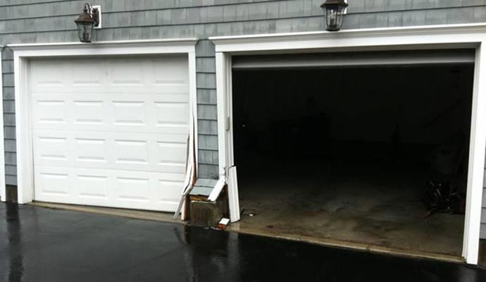 Structural damage to a garage door frame and trim following a vehicle impact