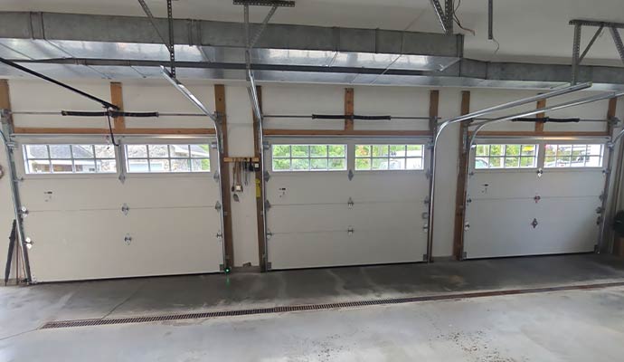 Three residential overhead garage doors in a home garage