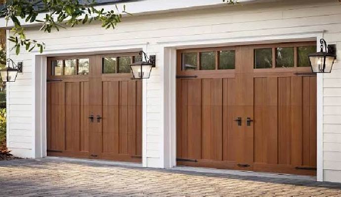 Two Clopay wood carriage house garage doors installed on a residential garage