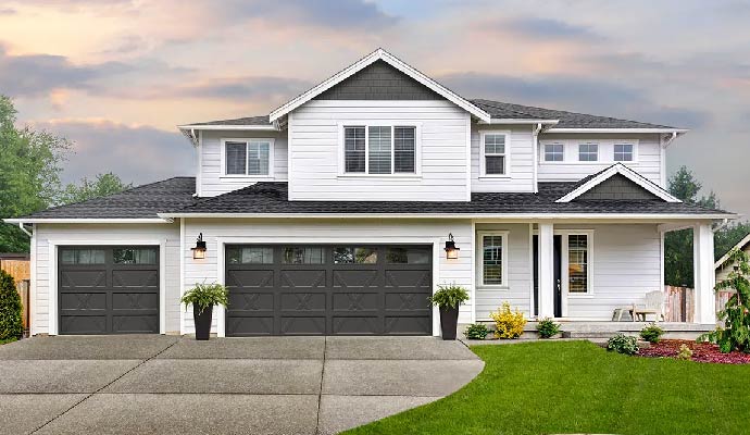 Two-story residential home with matching dark grey Clopay garage doors